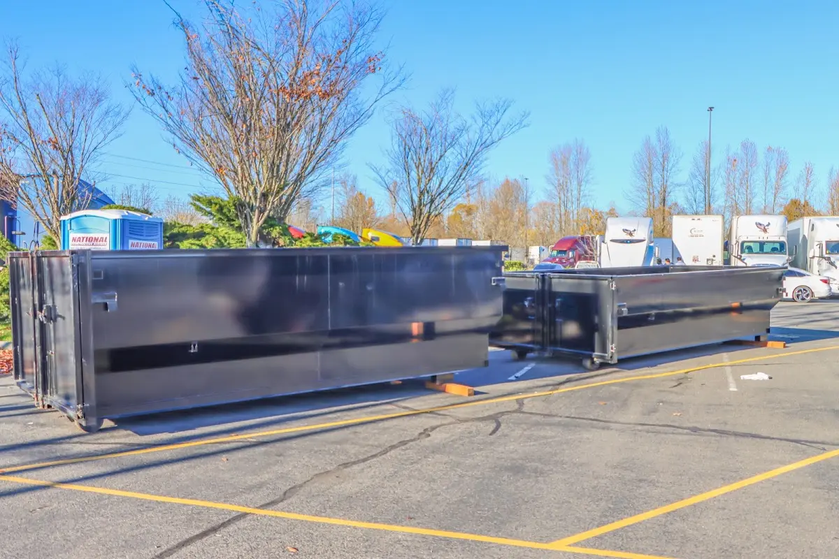 Professional dumpster rental service with roll-off container on residential driveway in Kasson